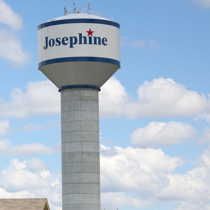 Josephine water tower against a blue Texas sky